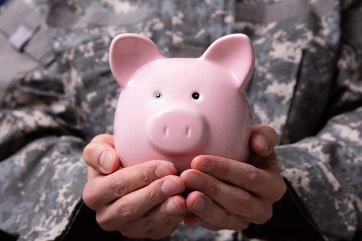 soldier holding piggy bank